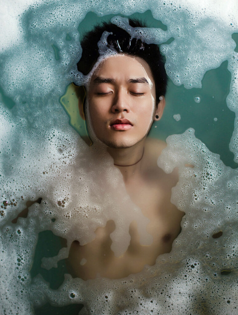 Young man floating in water, wondering if masturbation causes ED