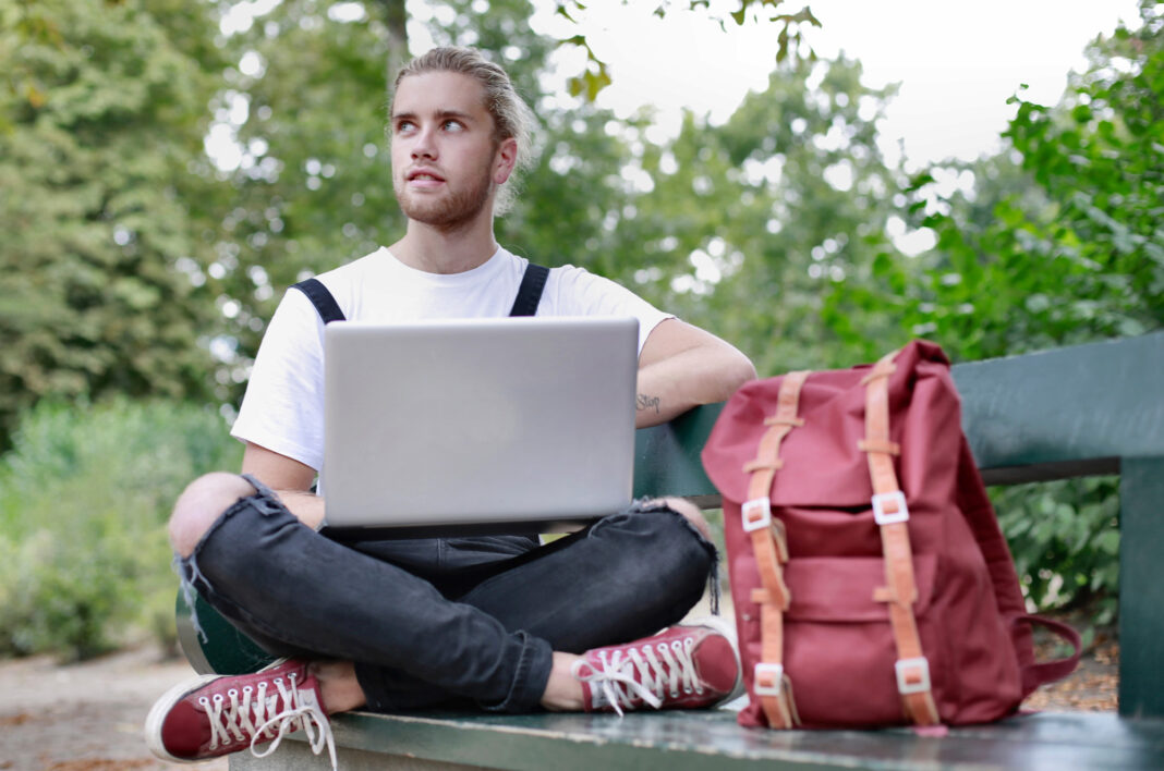 Young man writing an online dating profile