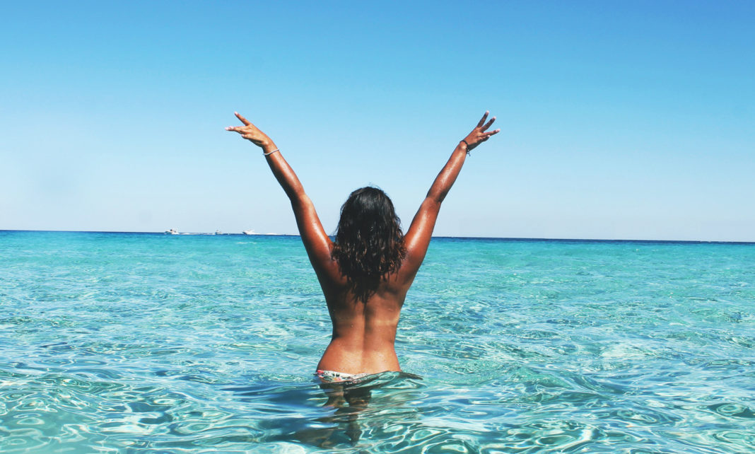 Woman in the sea, practicing ecosexuality