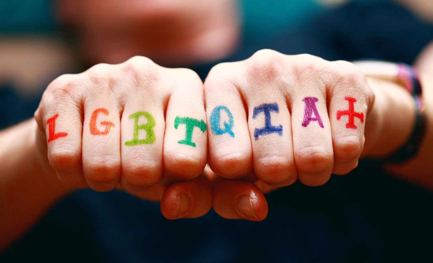 LGBTQIA+ on hands showing that asexuality is part of an orientation.