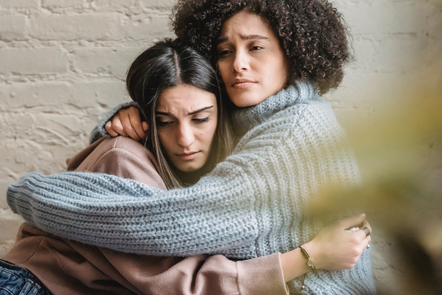 Two women hugging, wondering how to stop being jealous