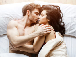 man and woman in bed, experimenting with the best foreplay ideas for men