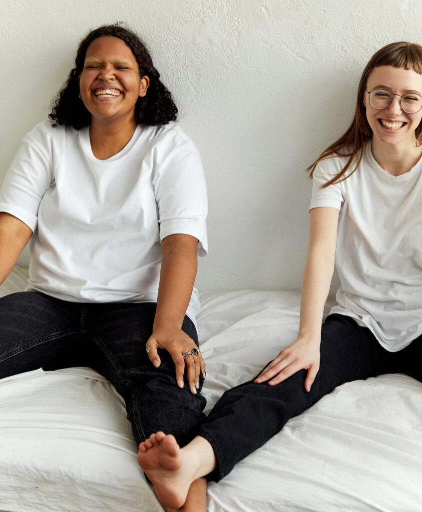 Laughing lesbian girls experiencing an awkward sex moment