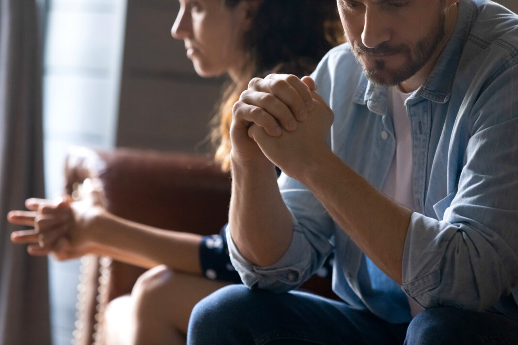 Man and woman wondering how to resolve conflict in a relationship