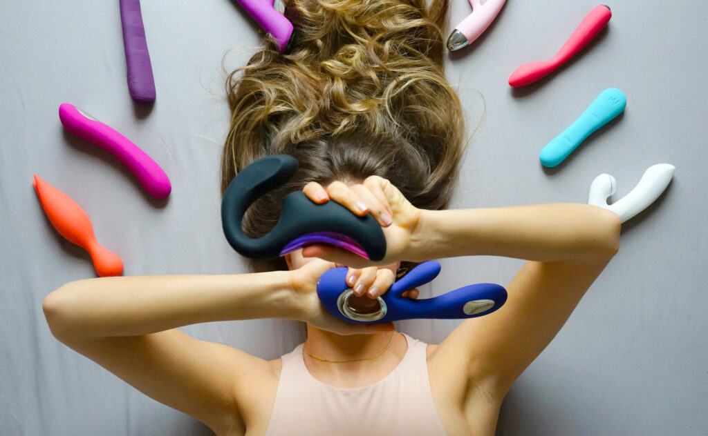 Woman surrounded by sex toys