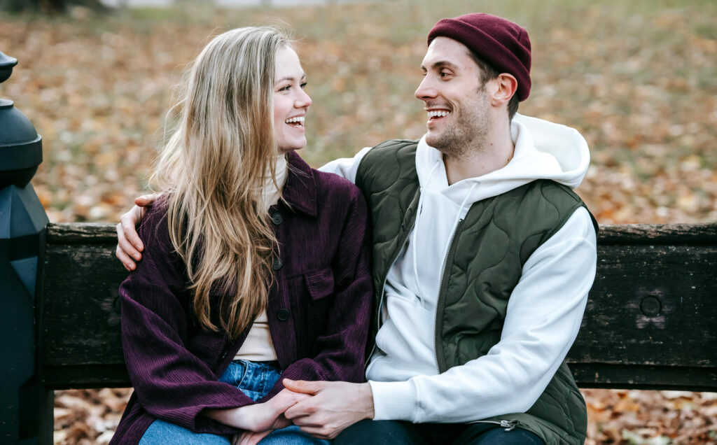 Two people sitting on a bench, learning how to date