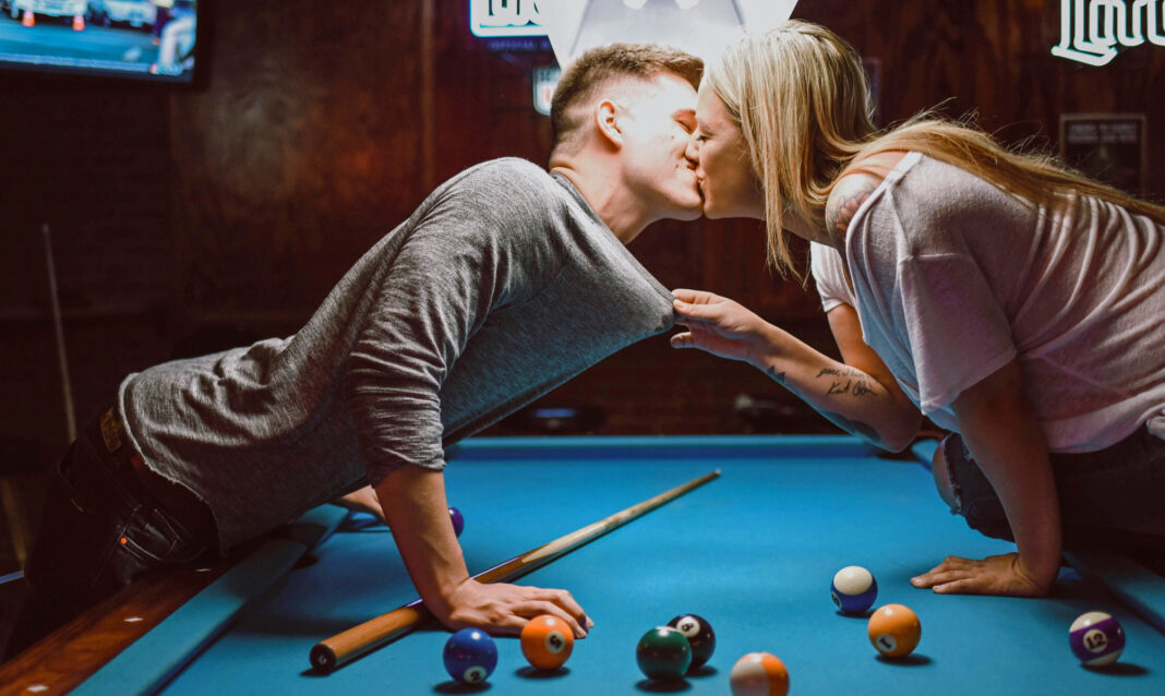 couple kissing on pool table following hookup rules