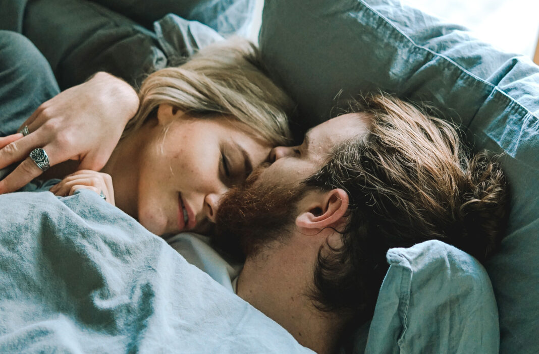 Couple in bed, dealing with grief and sex